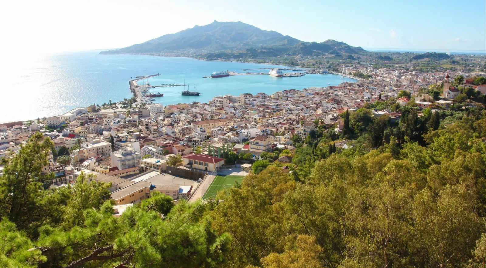 Zakynthos Town and its harbour seen from the hill at Bochali, with mountains across the bay.